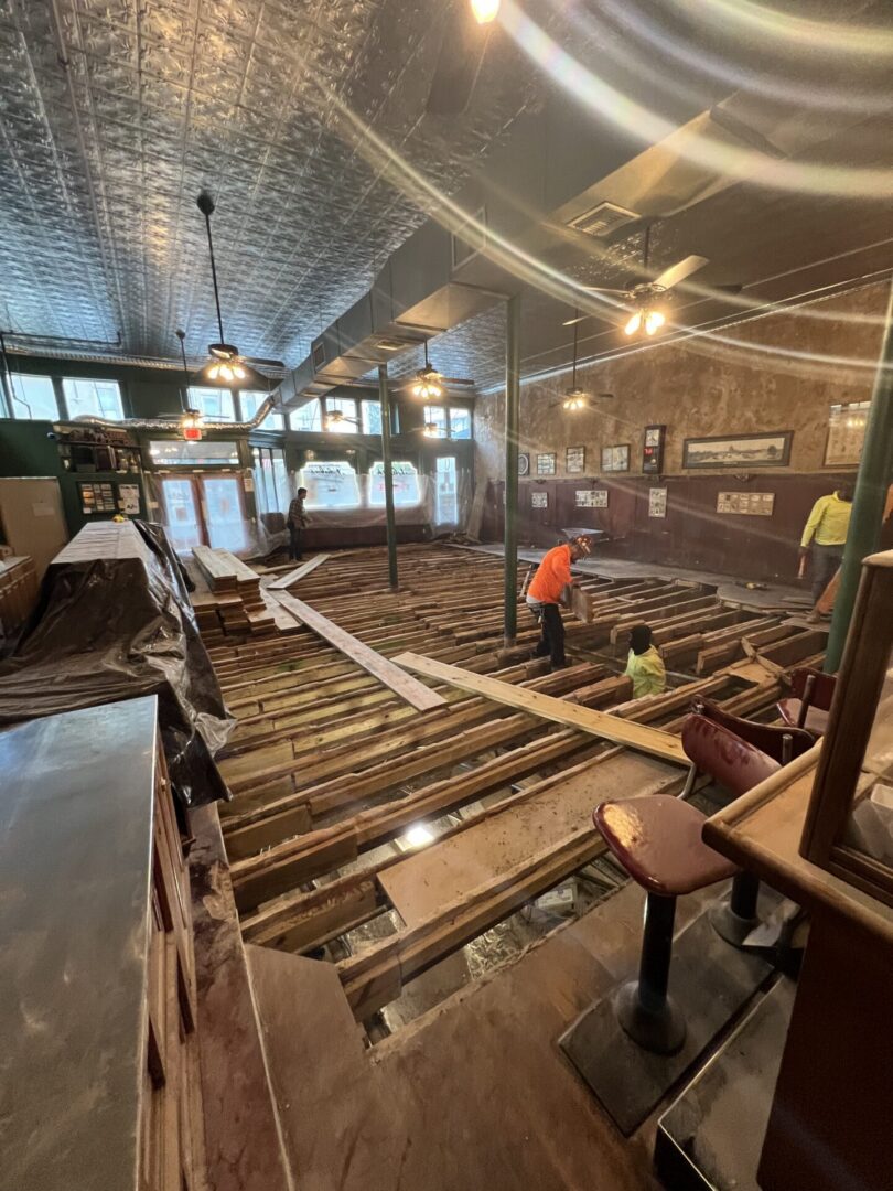 Bar interior under renovation with exposed floor joists