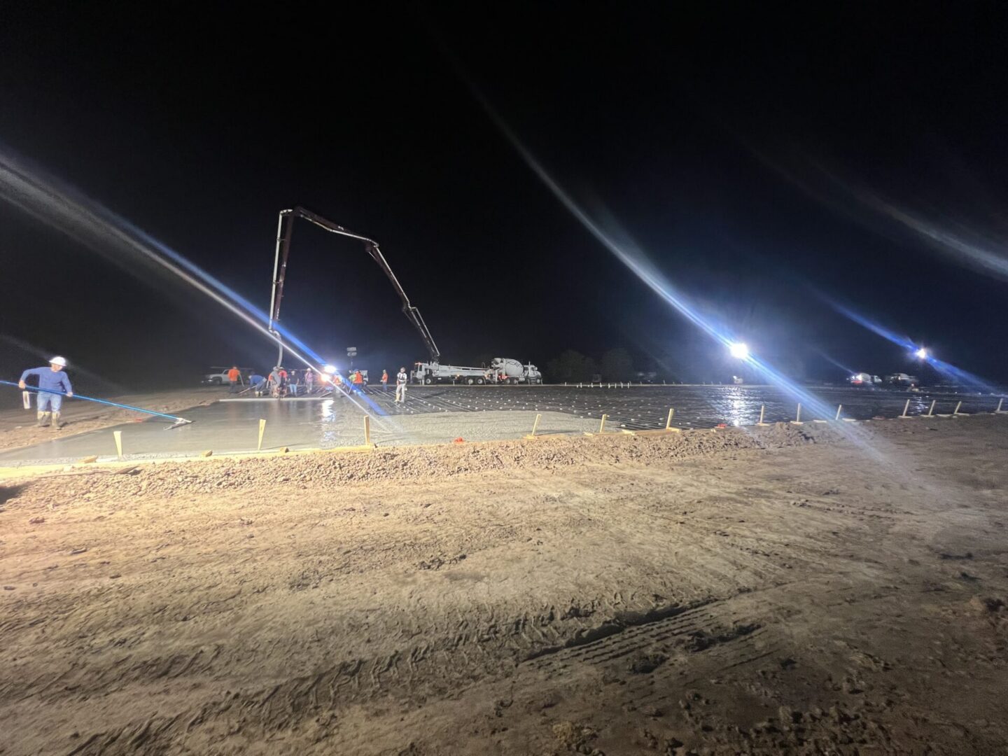 Construction site featuring steel framework and machinery, highlighting the future installation of Metallic Epoxy Flooring.
