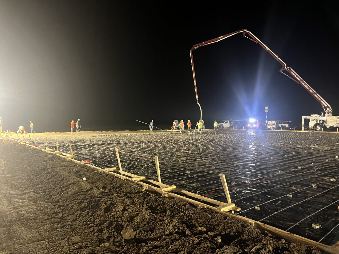 Construction site featuring steel framework and machinery, highlighting the future installation of Metallic Epoxy Flooring.
