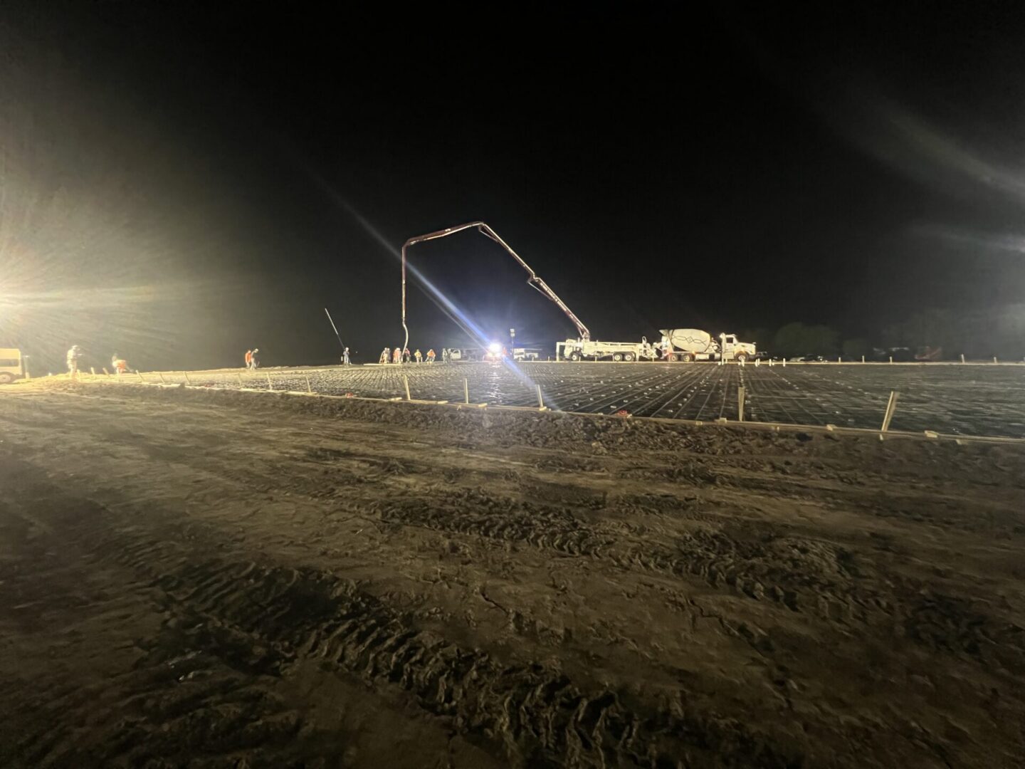 Construction site featuring steel framework and machinery, highlighting the future installation of Metallic Epoxy Flooring.