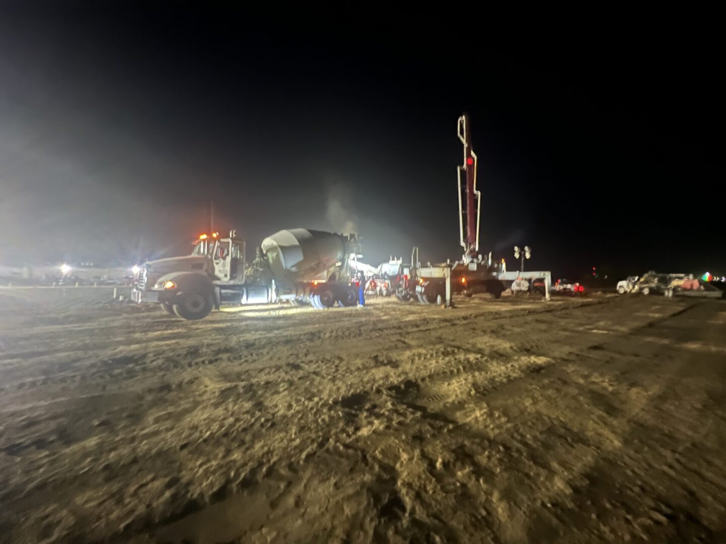 Construction site featuring steel framework and machinery, highlighting the future installation of Metallic Epoxy Flooring.