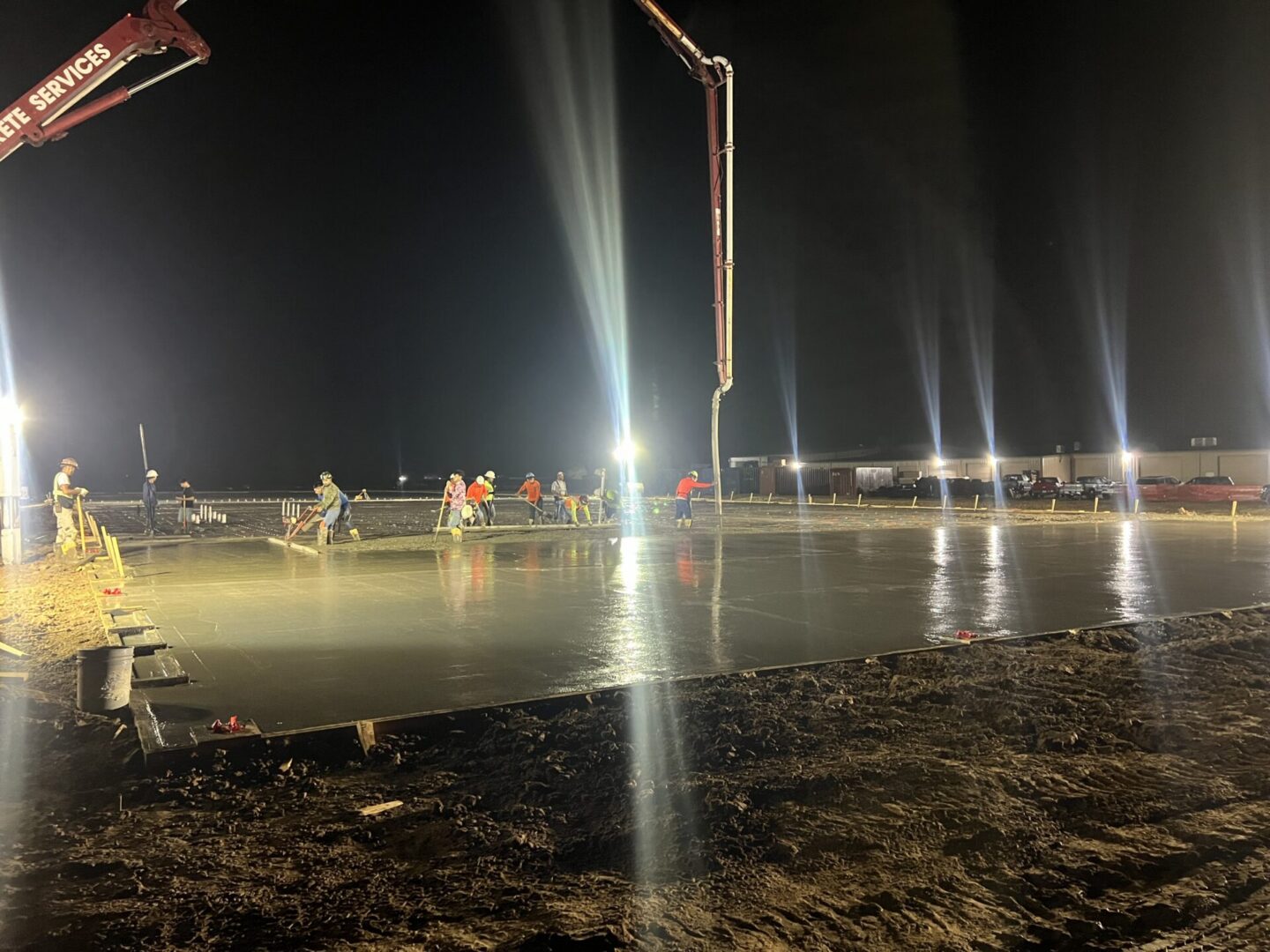 Construction site featuring steel framework and machinery, highlighting the future installation of Metallic Epoxy Flooring.