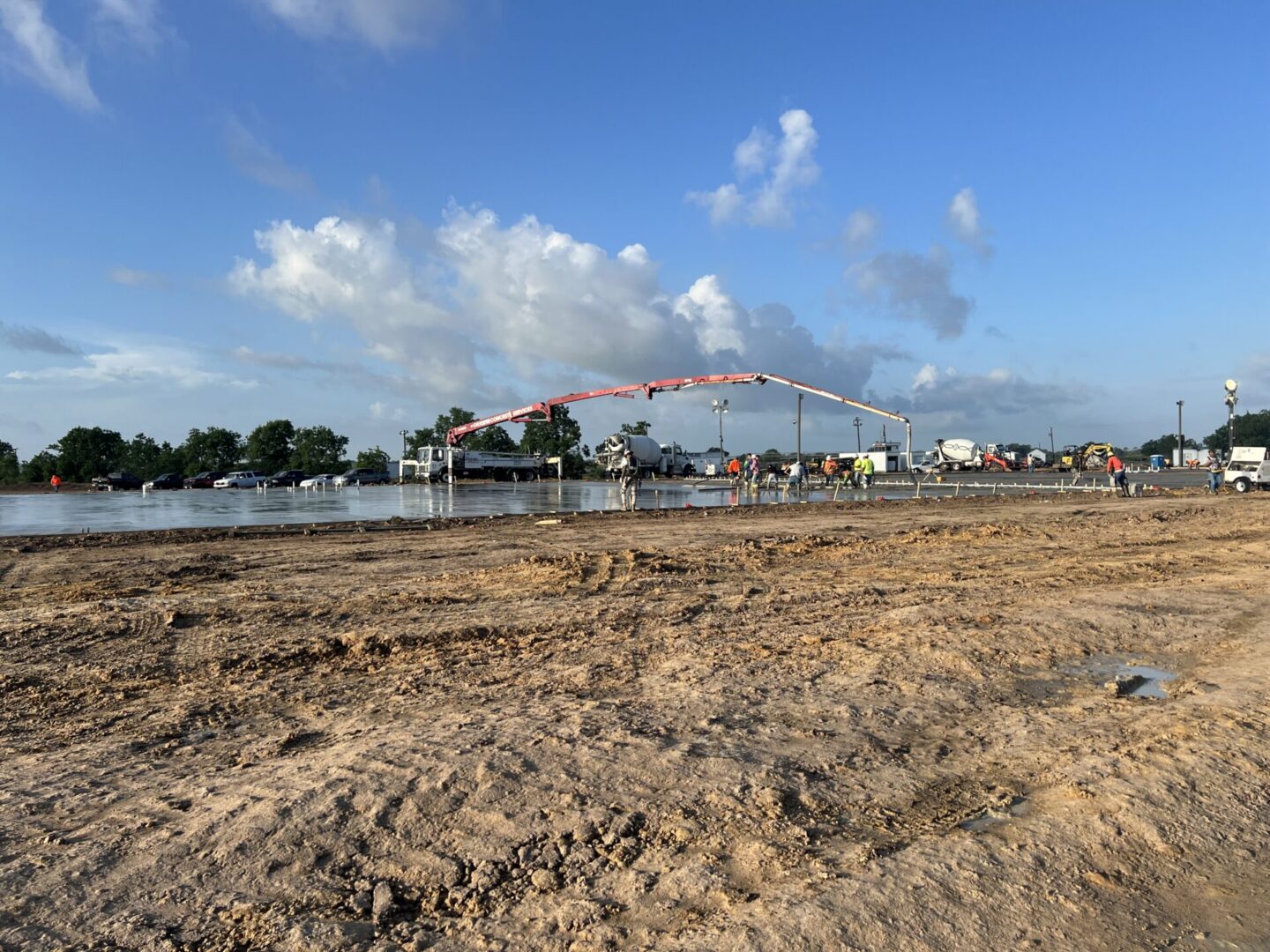 Construction site featuring steel framework and machinery, highlighting the future installation of Metallic Epoxy Flooring.