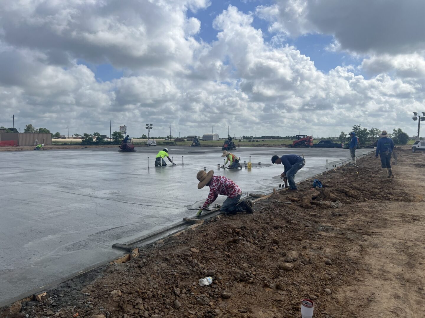 Construction site featuring steel framework and machinery, highlighting the future installation of Metallic Epoxy Flooring.