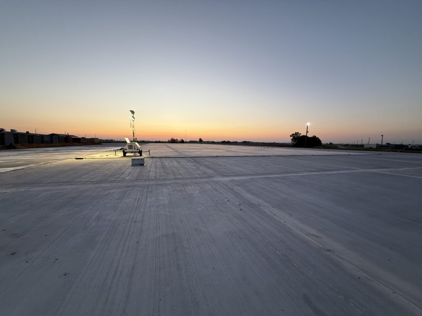 Construction site featuring steel framework and machinery, highlighting the future installation of Metallic Epoxy Flooring.