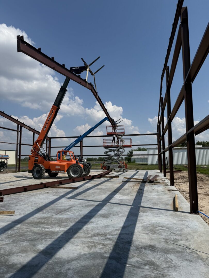 Construction site featuring steel framework and machinery, highlighting the future installation of Metallic Epoxy Flooring.
