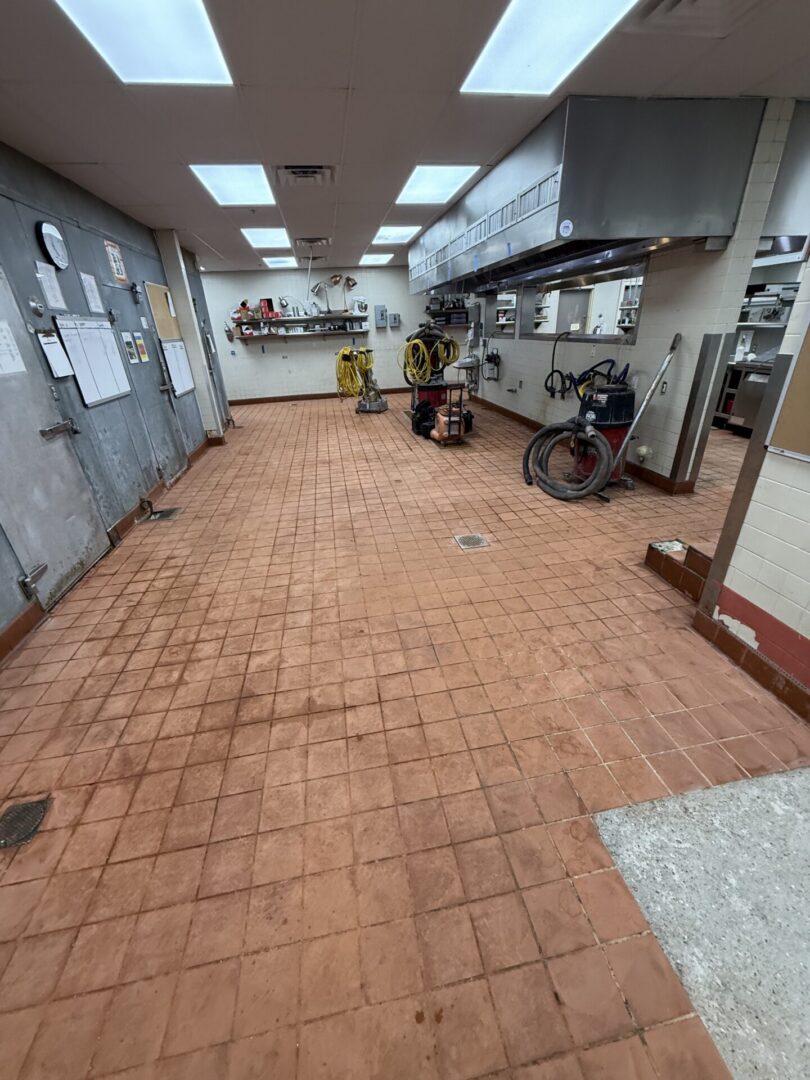 Empty commercial kitchen with cleaning equipment