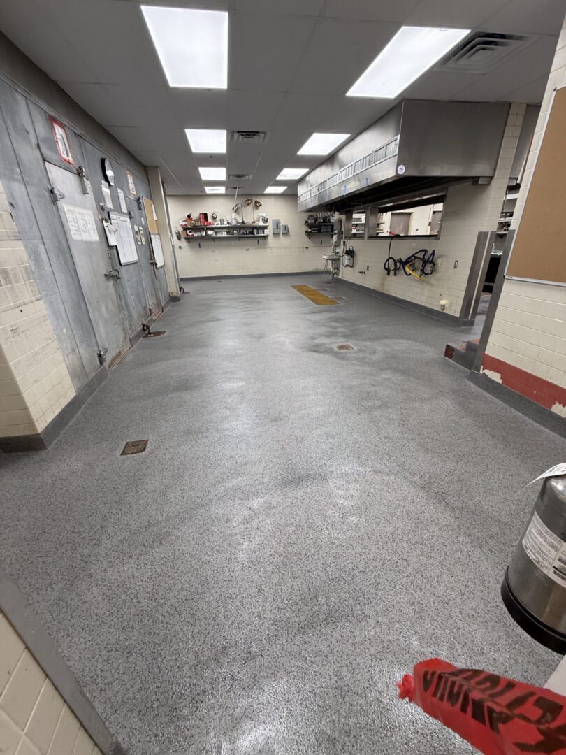 Empty commercial kitchen with stainless steel hood