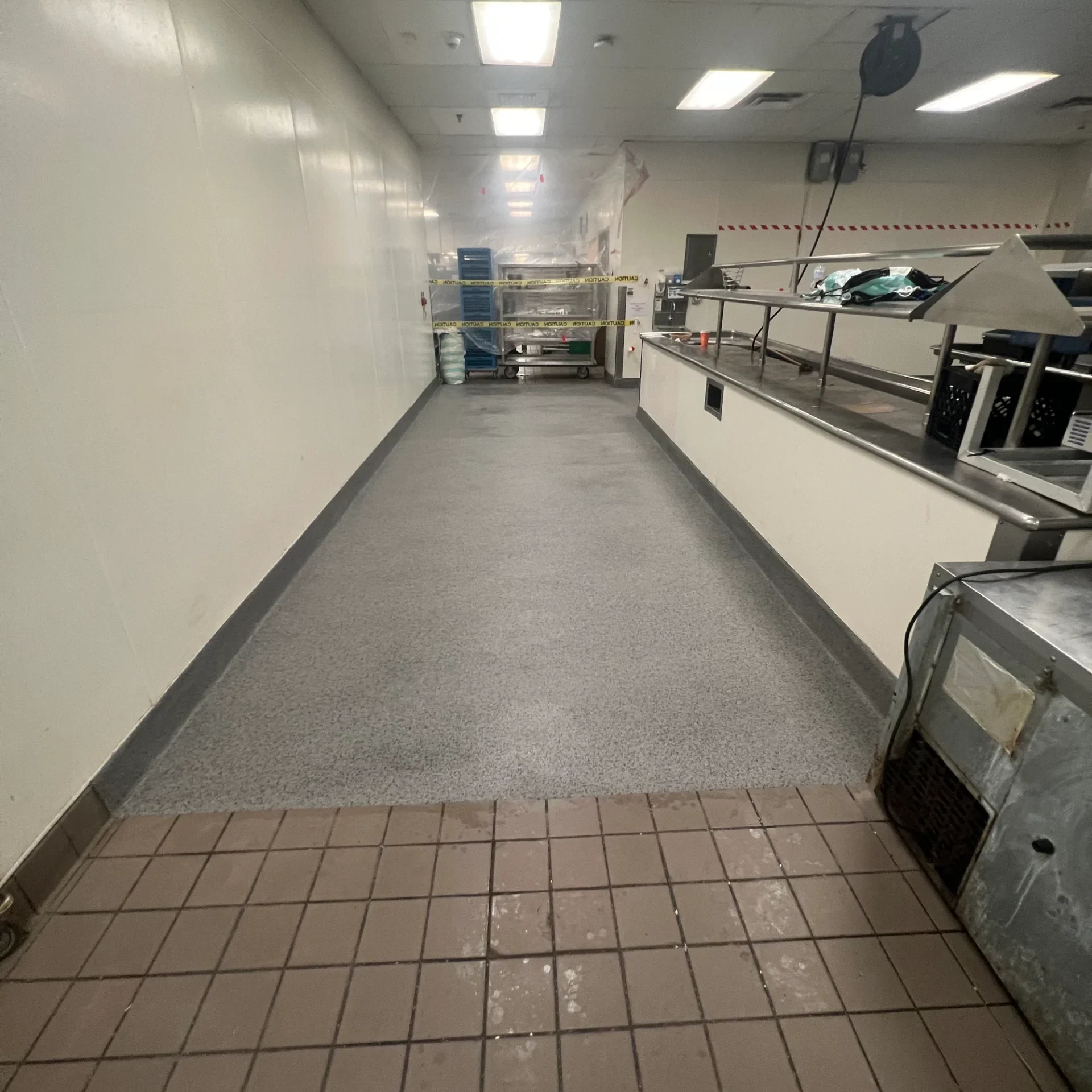 Empty industrial kitchen with stainless steel equipment.